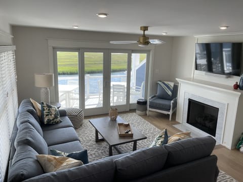 Family room with bay views, gas fireplace, and 55in TV.