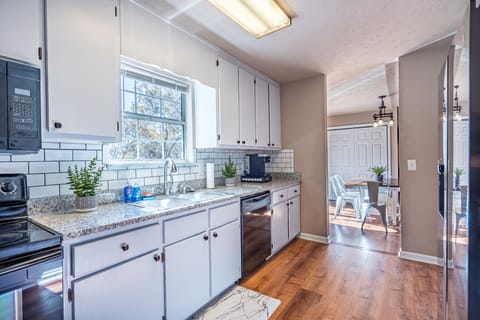 The kitchen has easy access to the dining table.