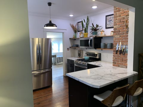 Remodeled Open Kitchen and Sun Room Behind.