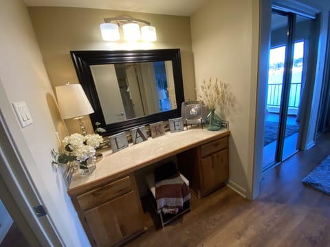 Vanity in the master bedroom filled with extra towels, blow dryer too. 