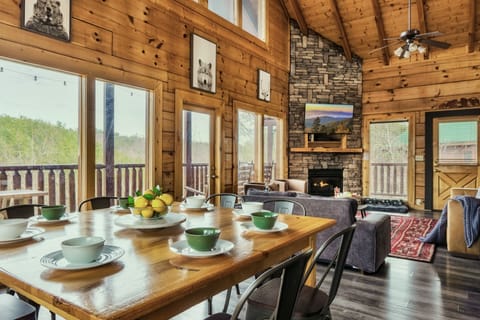 Open space living and dining room with Cathedral ceiling, fireplace and views!