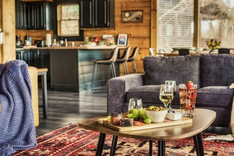 Open space living and dining room with Cathedral ceiling, fireplace and views!
