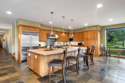 Fully stocked Chef’s kitchen seats up to 10 around the massive center island.