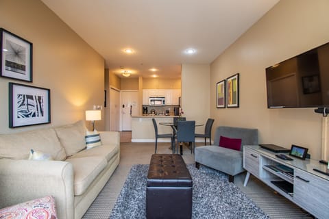 Spacious Living Room with a Premium Sleeper Sofa & a Private Balcony