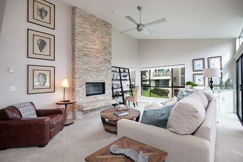 Living room with gas fireplace and ample light.