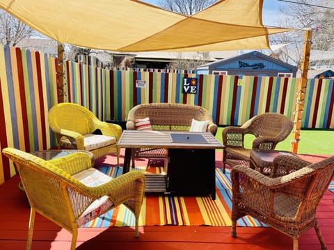 Cozy colorful outdoor patio seating with gas fire pit table.
