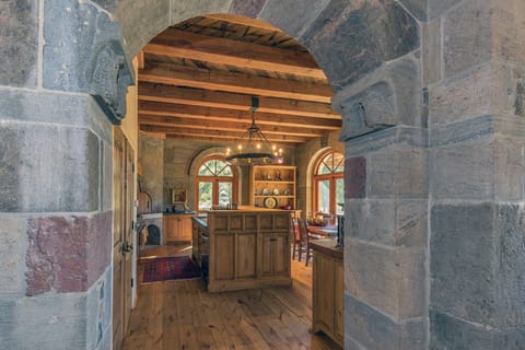 Handcrafted Stone Archway from Living and Dining to Kitchen