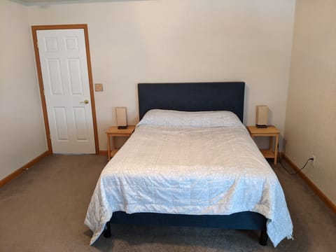 Master bedroom with separate reading lights, ceiling fan and noise machine.