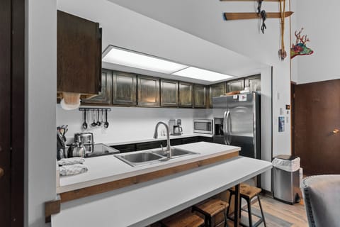 Full size kitchen with stainless steel appliances.