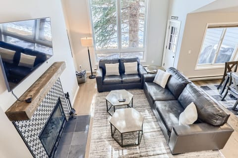 Open living room with wood-burning fireplace
