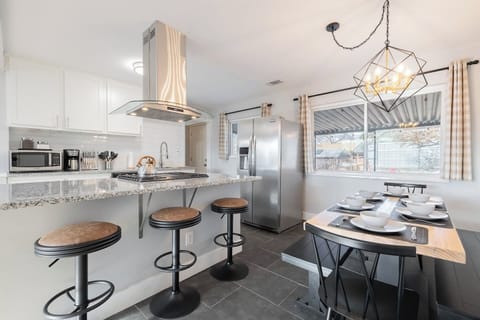 - Stylish kitchen with granite countertops and sleek stainless appliances
- Island seating and a fully set dining table make every meal feel like an occasion
- Natural light, modern lighting, and clean finishes bring warmth and function together