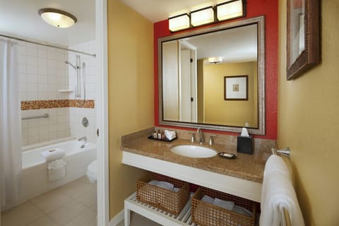 Bathroom with shower and tub. Basic toiletries and towels are provided
