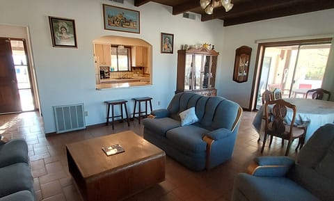 Living room showing kitchen hatch, front door and sliding doors to back porch