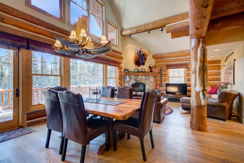 Dining table seats 10-12+ with mountain views.  Coyote pelts on support logs.