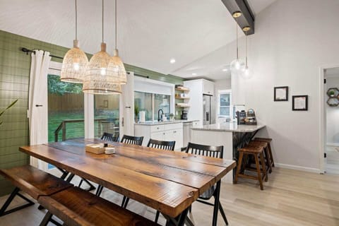 This gorgeous custom  dining table is the perfect place to dine with a group! This Pinterest worthy table was custom designed and built for this space out of reclaimed wood & steel.  Our carpenter & welder built it with your group in mind. 