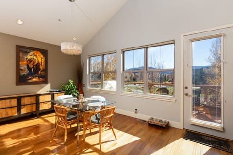 Dining area with direct access to 2nd floor deck, seating, and gas grill.