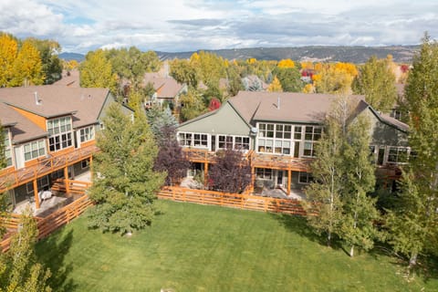 Private backyard opening adjacent to large green space.