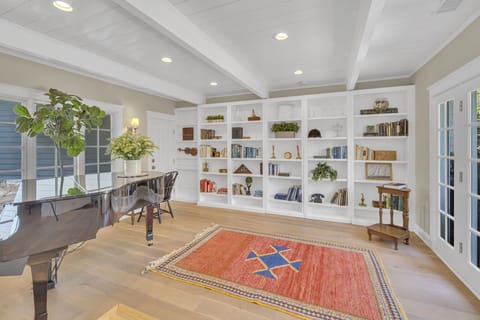 Quiet room with a piano and access to the back courtyard