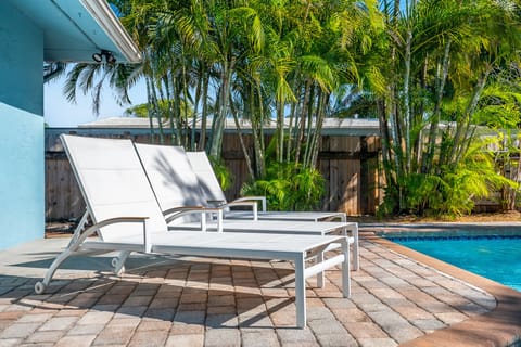 A heated pool, sun loungers