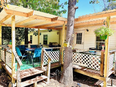 Covered back porch with lots of seating and beautiful woods.