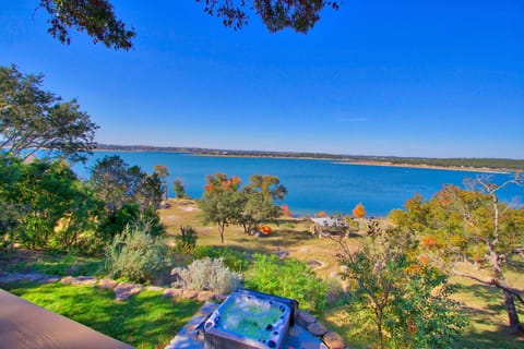 This property has lakefront access with a hot tub, fire pit, and lakeside gazebo!