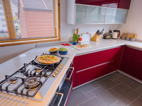 The modern kitchen has gas hob and double oven