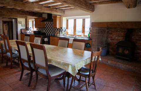 Log burner in the ingle nock fireplace of the kitchen