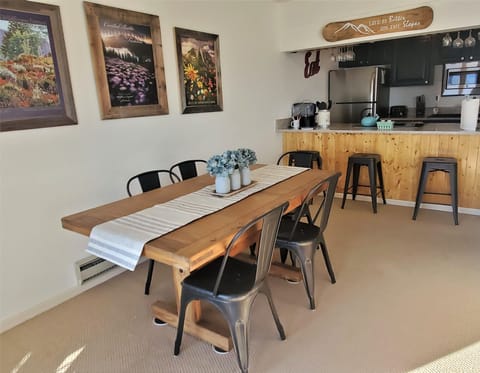 The dining area is adjacent to a bar that backs up to the kitchen.