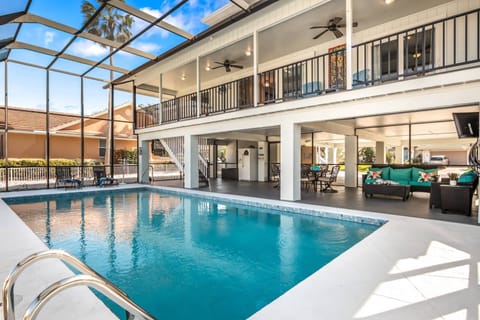 The Old Florida style home is all open on the ground level for entertaining and enjoying the pool with the living areas on the second and third levels