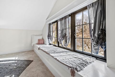 Our fifth bedroom has a King bed, window seat, closet, Smart TV, and en suite bathroom.