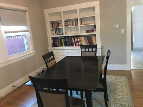 Dining room with books on a variety of subjects (travel guides, cooking, etc)