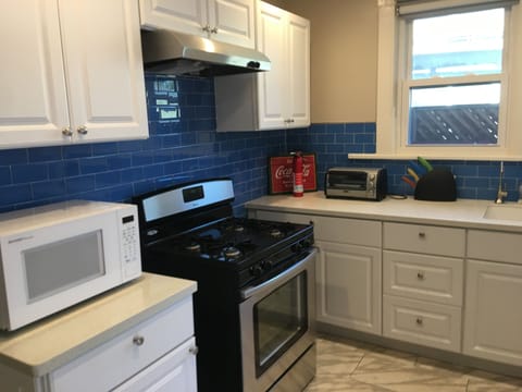 Kitchen with gas stove, oven, microwave