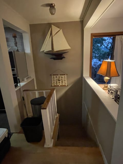 Stairwell to lower level game room, bunk room, half bath, patio and lake view.