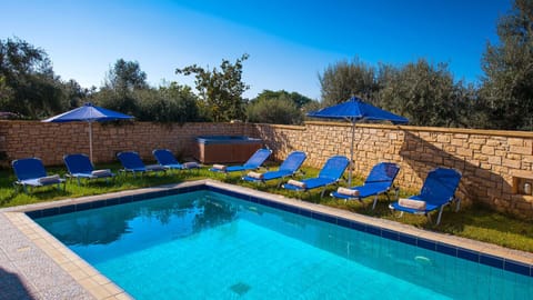 Pool area with 12 sun beds and umbrellas
