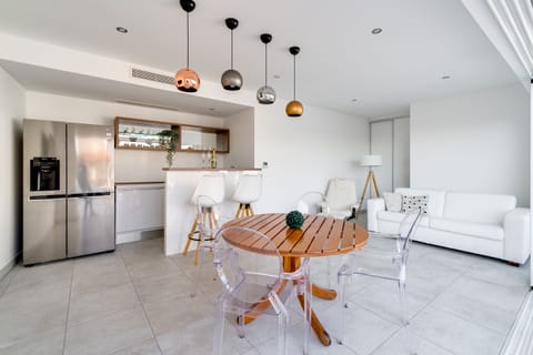 Modern summer kitchen and lounge area next to the pool
