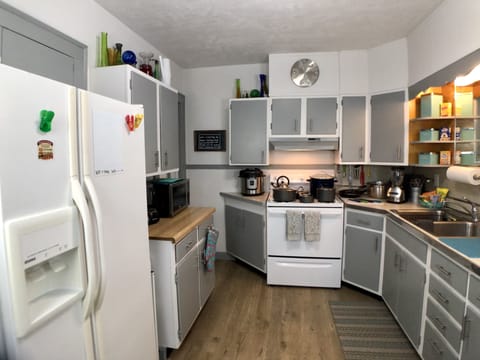 Kitchen is stocked with appliances, dishware, silverware, spices, and coffee.