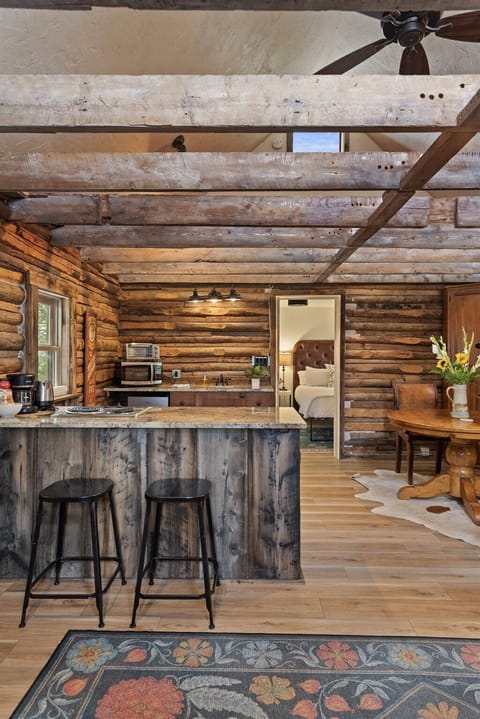 The kitchenette in our historic cabin is perfect for light cooking with a 2-burner stove, mini fridge and freezer, microwave, sink, and toaster.