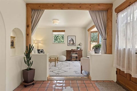 Cozy sun room for reading, relaxing, working. This room can be converted into a sleeping area with the curtains and pull-out queen-sized sofa bed.