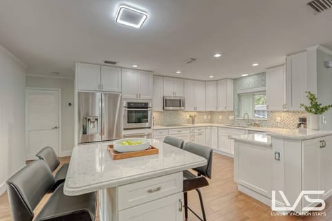 Open layout fully appointed eat in kitchen with island for 4, stainless steel refrigerator with filtered water/ice maker, Keurig machine for pod or regular drip coffee, toaster, microwave, filtered water etc. Look on listing for a detailed list of everything located inside kitchen.