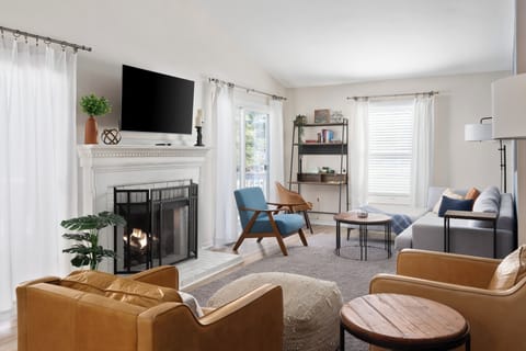 Spacious living room offers plenty of seating, cozy fireplace and Roku Smart TV.