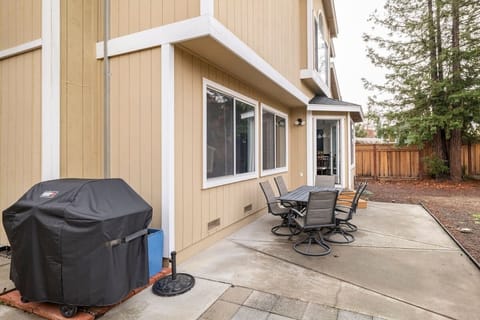 Backyard with propane BBQ and dining tables. Fully fenced.