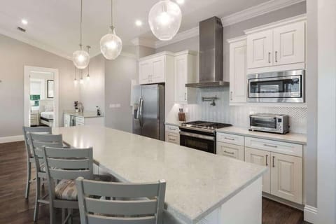 Gourmet kitchen equip with blender, Keurig coffee machine, crockpot, lots of cookware, and enough dishes and dining utensils for everyone.