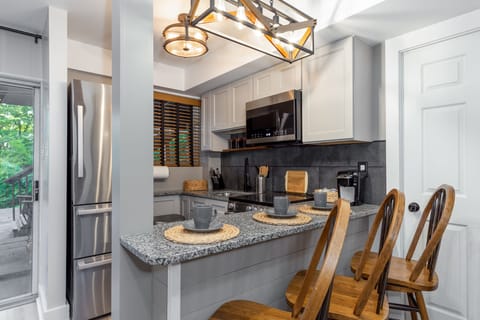 Downstairs kitchen has fridge with ice maker, stove, oven, and microwave