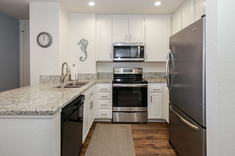 Fully stocked kitchen with stainless steel appliances