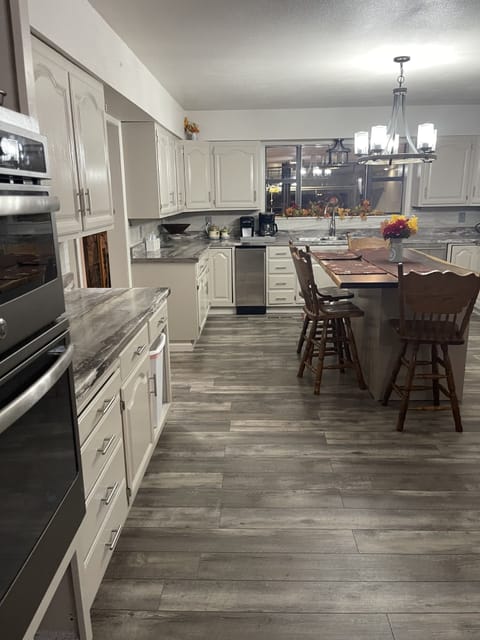 Kitchen. Island sits 4 chairs.commercial ice maker under counter