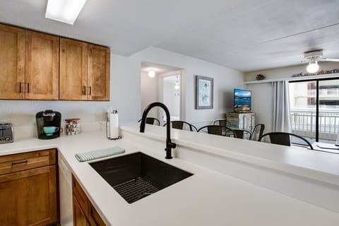 New cabinets, countertop, and sink in the well-stocked kitchen