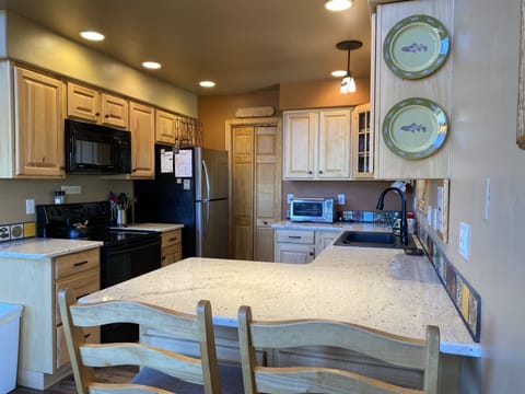 In the Kitchen, there is plentiful counter space and high-top seating for two at the bar.