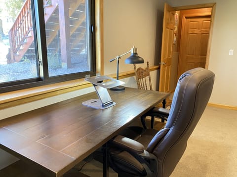 The Office space has a large desk facing a bright window, walkout access through the french doors...