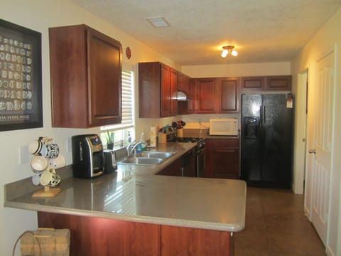 Kitchen is well stocked with most appliances, pots, pans, dishes and utensils.