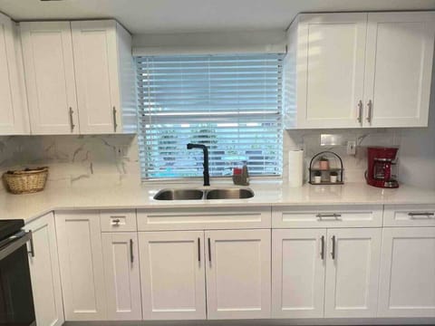 Open concept full kitchen with a fridge, oven, stovetop, coffee pot, toaster and anything else you might need to feel at home! The kitchen is fully equipped with anything you need for a home cooked meal